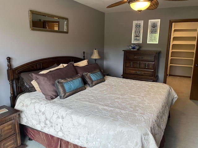 bedroom featuring ceiling fan, a spacious closet, carpet floors, and a closet