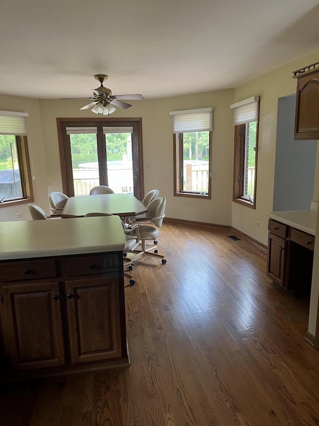 kitchen featuring dark hardwood / wood-style floors, ceiling fan, and dark brown cabinets