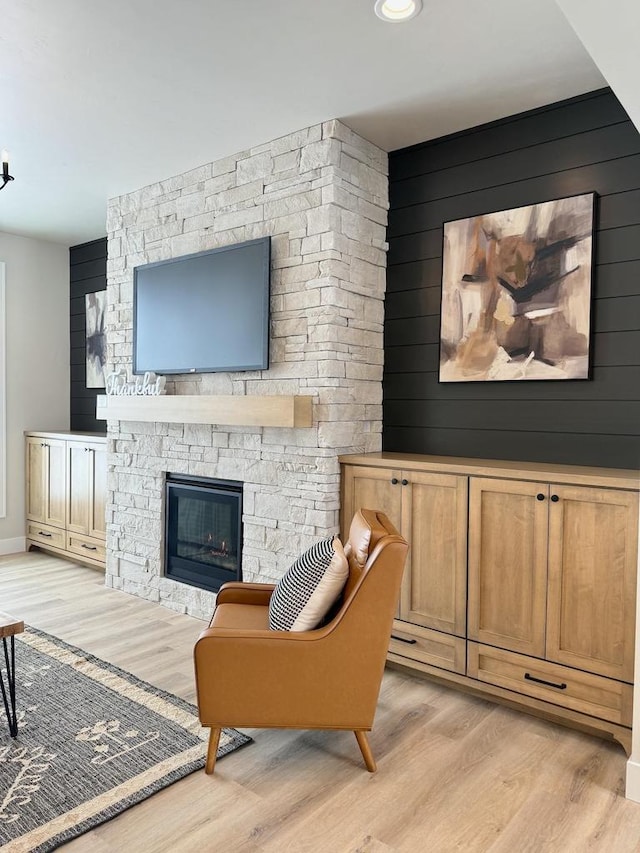 5090 N Cobble Creek Dr, Grand Chute, WI 54913 - living room with light wood-style flooring, a stone fireplace, and baseboards
