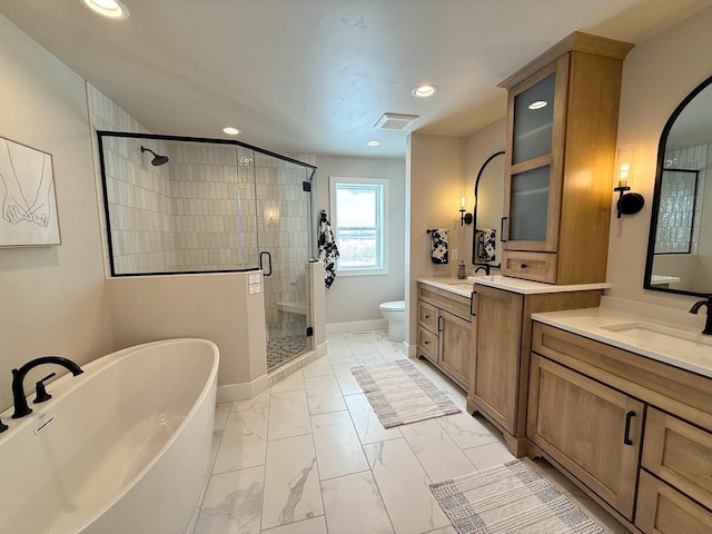 5090 N Cobble Creek Dr, Grand Chute, WI 54913 - bathroom featuring marble look tiles, a shower stall, a freestanding tub, recessed lighting, and vanity