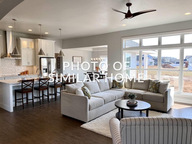 living room with dark wood-style floors, ceiling fan, and recessed lighting