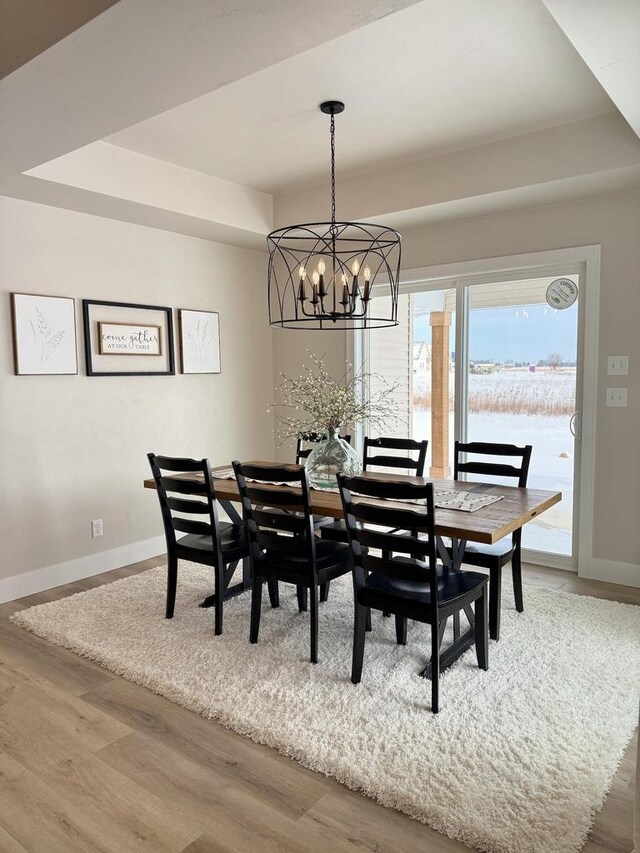 5090 N Cobble Creek Dr, Grand Chute, WI 54913 - dining room featuring a chandelier, wood finished floors, and baseboards