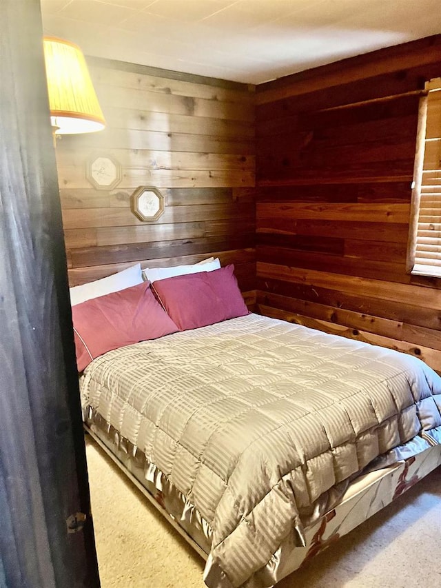 bedroom featuring wood walls and carpet floors