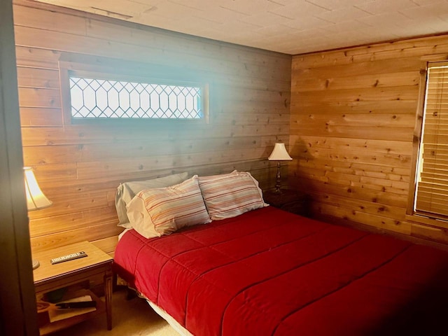 bedroom featuring wood walls