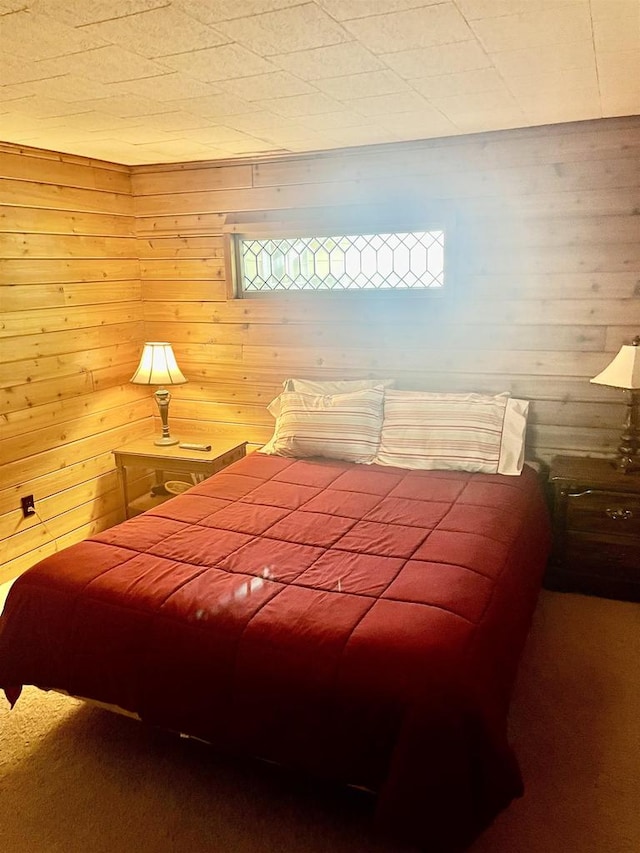 carpeted bedroom with wooden walls