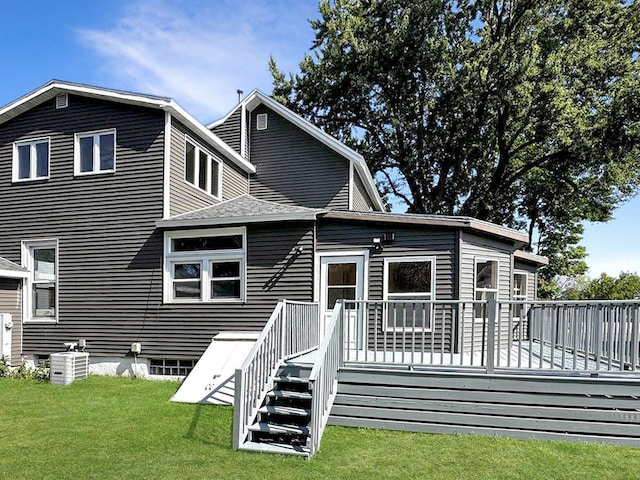 rear view of house featuring a lawn, a deck, and central air condition unit