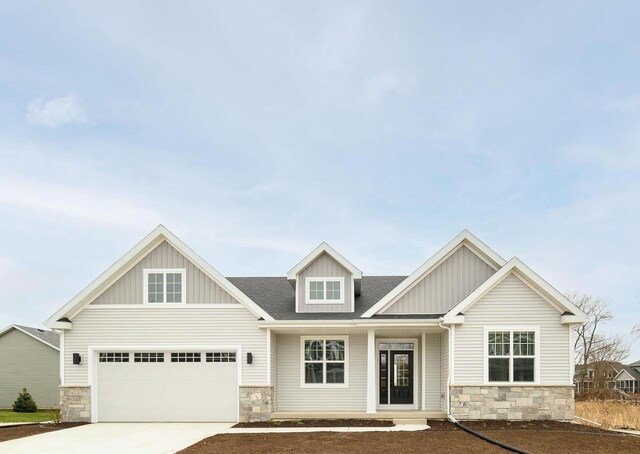 craftsman-style home with a front yard and a garage