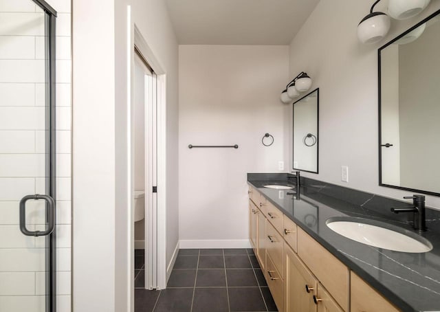 bathroom with toilet, vanity, tile patterned floors, and an enclosed shower