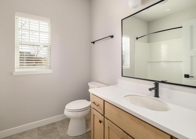 bathroom with tile patterned flooring, vanity, and toilet