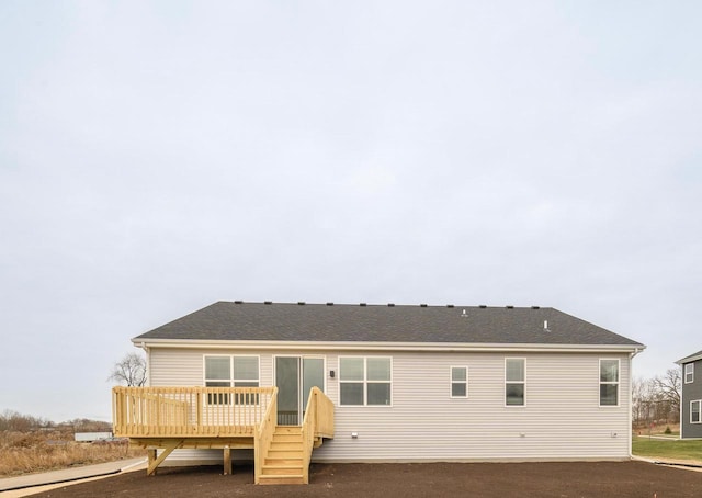 rear view of house featuring a wooden deck