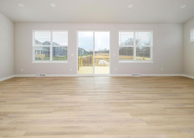 spare room with light hardwood / wood-style flooring