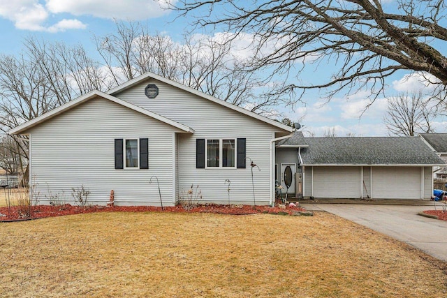 ranch-style house featuring a garage, concrete driveway, and a front yard