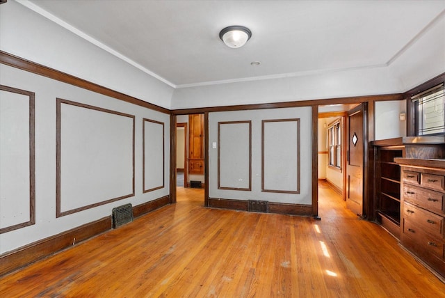 unfurnished bedroom featuring visible vents and hardwood / wood-style floors