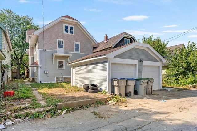 exterior space featuring a garage and an outdoor structure