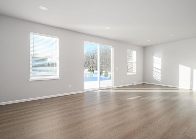 spare room with a healthy amount of sunlight and light wood-type flooring