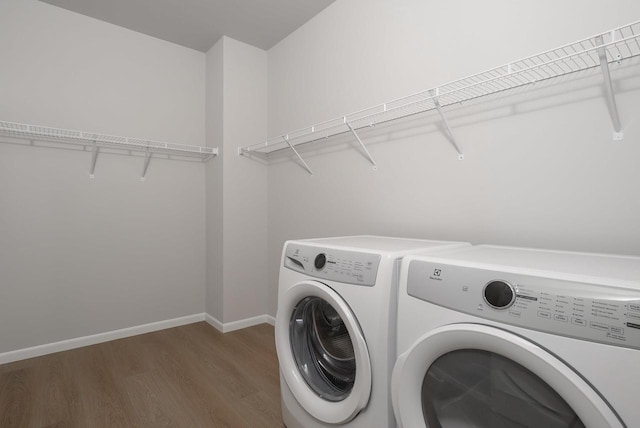 washroom featuring independent washer and dryer and dark wood-type flooring