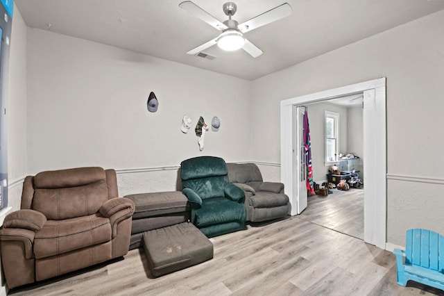 living room featuring light hardwood / wood-style flooring and ceiling fan