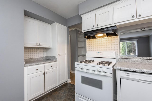 kitchen with white cabinets, white appliances, and dark tile patterned floors