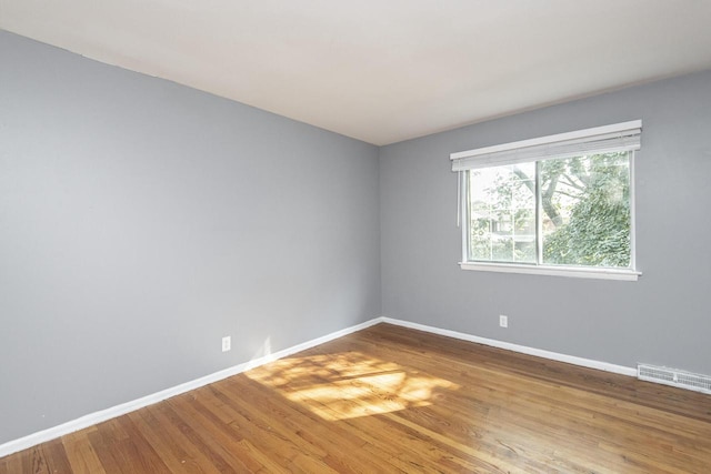 unfurnished room featuring hardwood / wood-style flooring