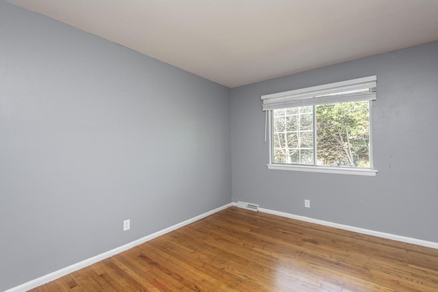 spare room featuring hardwood / wood-style flooring