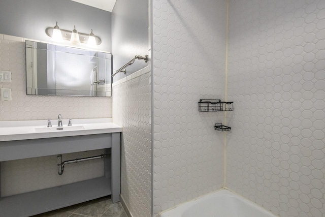 bathroom with vanity, tiled shower / bath combo, and tile patterned floors