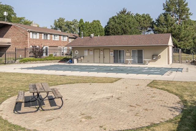 back of house featuring a community pool and a patio