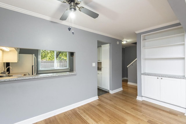 unfurnished room with ceiling fan, ornamental molding, and light wood-type flooring