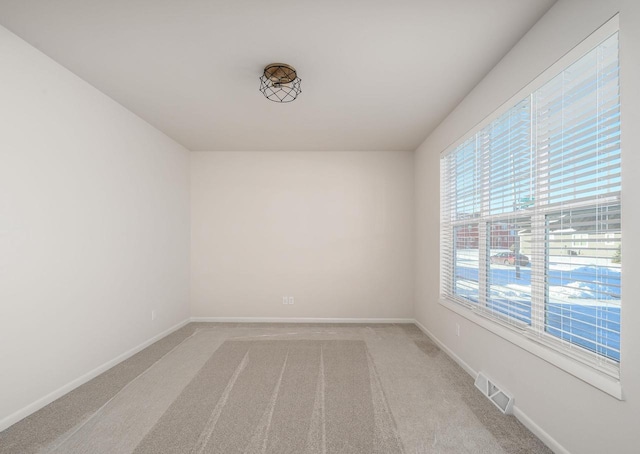 unfurnished room with carpet flooring and plenty of natural light