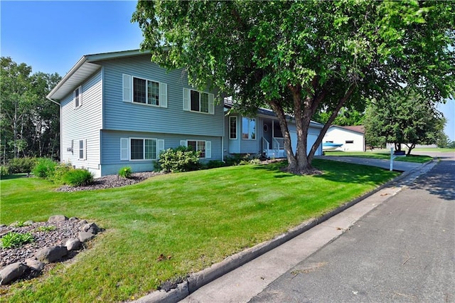 split level home featuring a front lawn