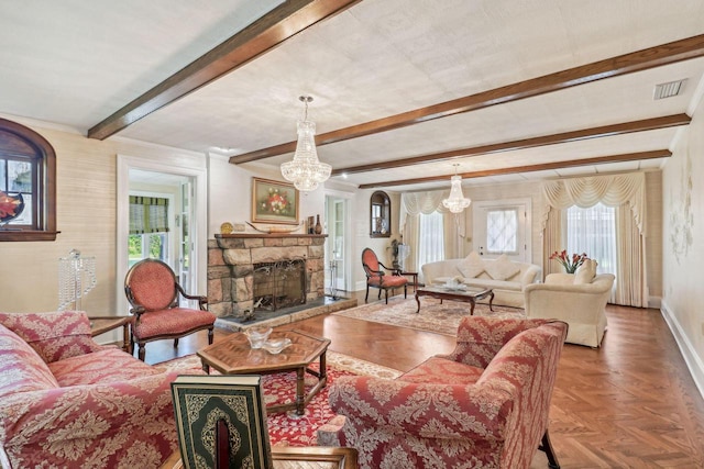 living room with beam ceiling, plenty of natural light, an inviting chandelier, and a stone fireplace