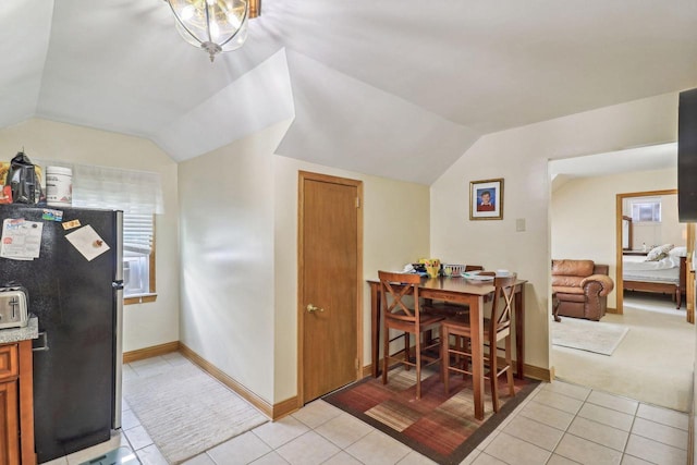 tiled dining space with vaulted ceiling