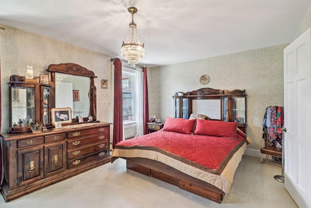 carpeted bedroom featuring an inviting chandelier