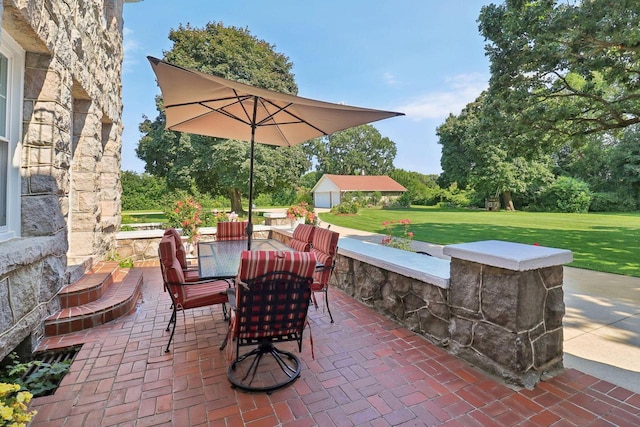 view of patio featuring an outbuilding