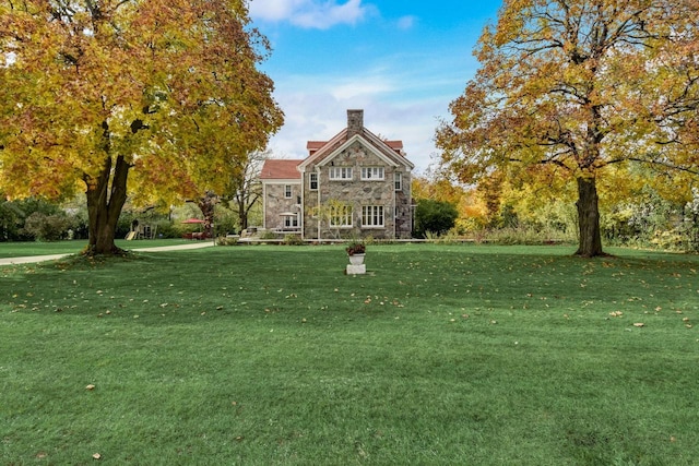 view of property's community with a lawn