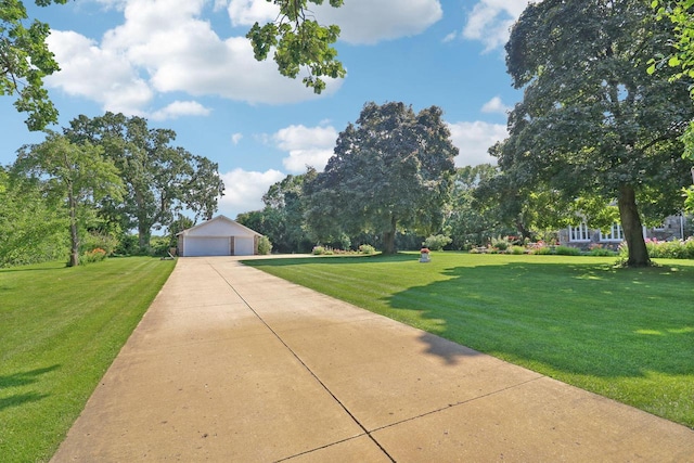 view of property's community featuring an outdoor structure and a lawn