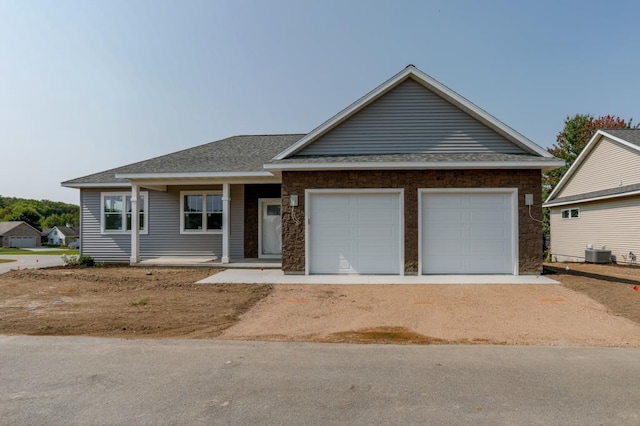 view of front of home with a garage and cooling unit