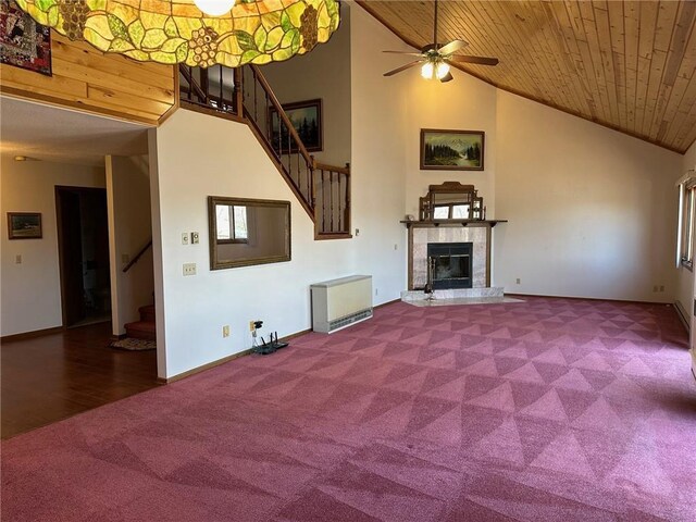 unfurnished living room featuring a tile fireplace, wooden ceiling, hardwood / wood-style floors, high vaulted ceiling, and ceiling fan