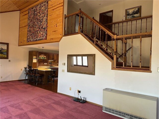 staircase with radiator and carpet