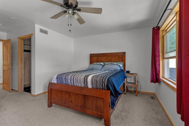 bedroom featuring ceiling fan and light carpet