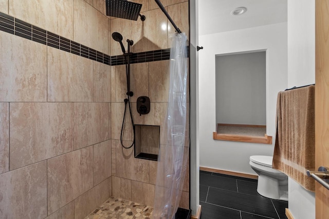 bathroom with toilet, curtained shower, and tile patterned flooring