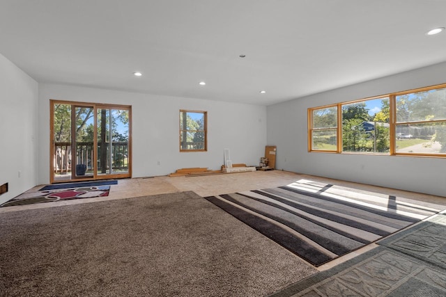 unfurnished living room with light colored carpet