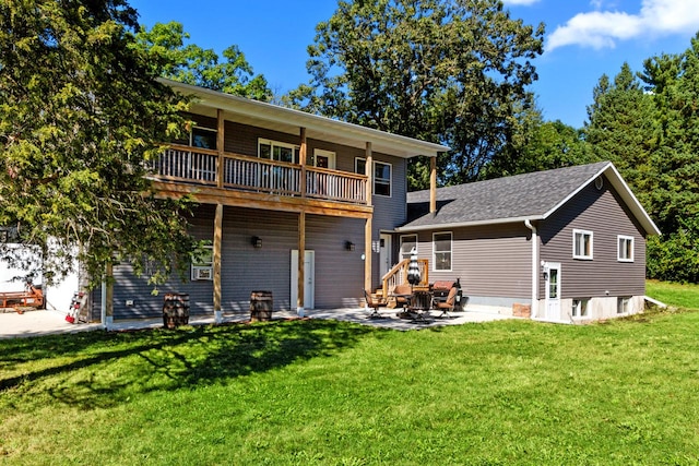 view of front of house with a balcony, a front lawn, and a patio area