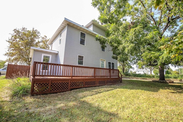 back of house with a wooden deck and a yard