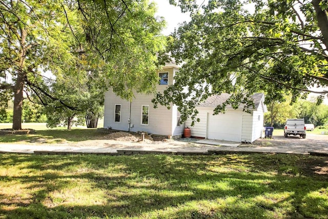 view of front of property featuring a garage and a front lawn