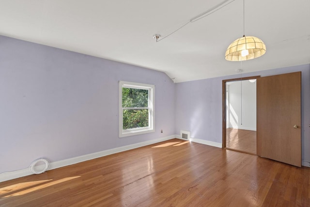 interior space with wood-type flooring and vaulted ceiling