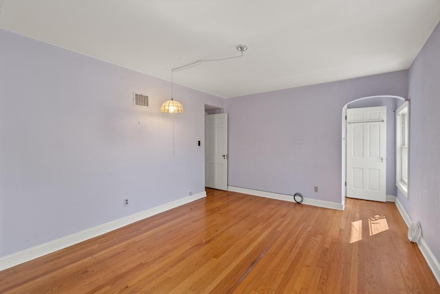 unfurnished room with light wood-type flooring