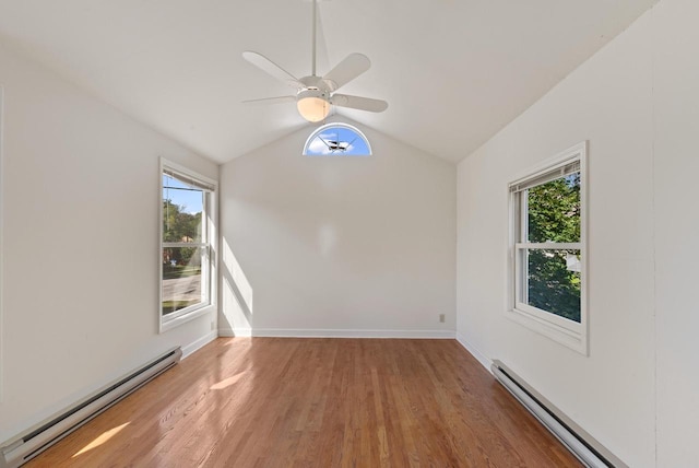 unfurnished room featuring ceiling fan, a baseboard radiator, and a wealth of natural light