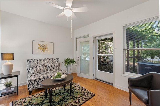 sitting room with ceiling fan and hardwood / wood-style flooring