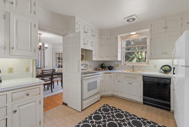 kitchen with light hardwood / wood-style floors, white cabinetry, white appliances, sink, and a chandelier