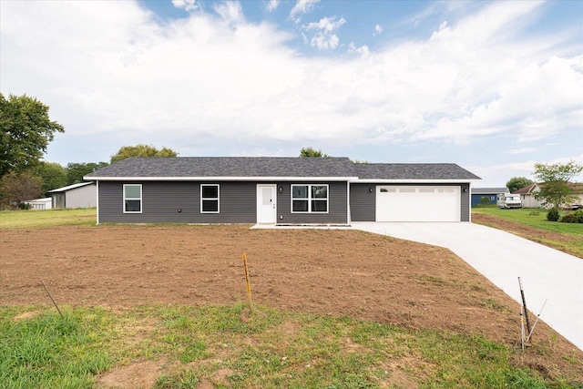 single story home with a garage, concrete driveway, and a front yard